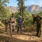 Travelers doing a walking jungle safari with a guide in Satpura Tiger Reserve Madhya Pradesh